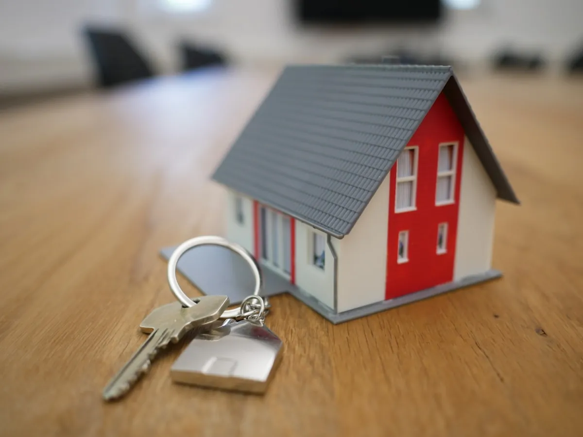 A real estate negotiator handing keys to a happy new homeowner