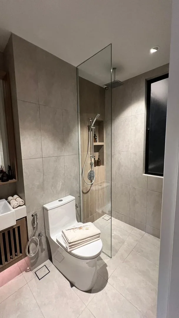 Amaya Residences show unit — bathroom with rain shower and glass screen