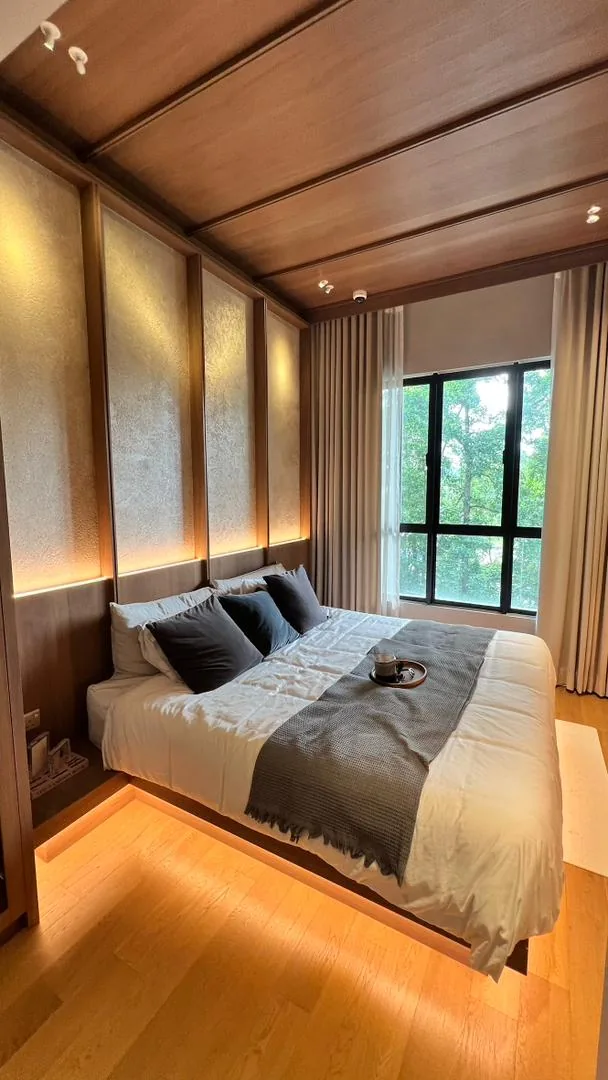 Amaya Residences show unit — bedroom with floating bed and textured headboard