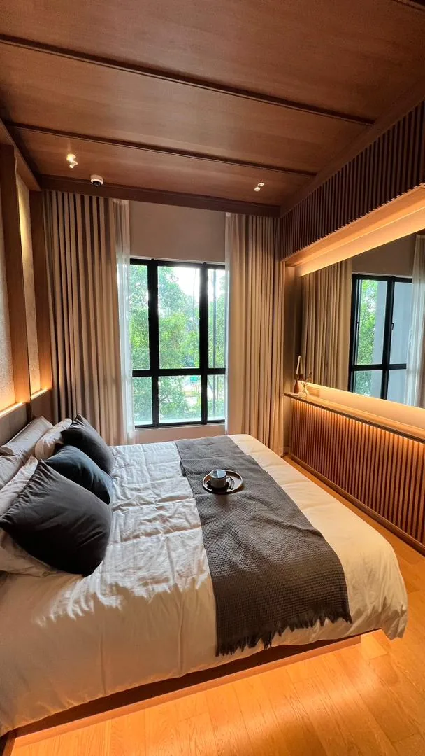 Amaya Residences show unit — bedroom with warm timber ceiling