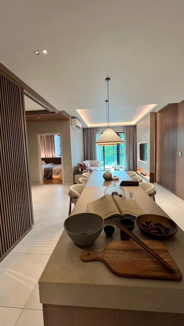 Amaya Residences show unit — open-plan living and dining with kitchen island