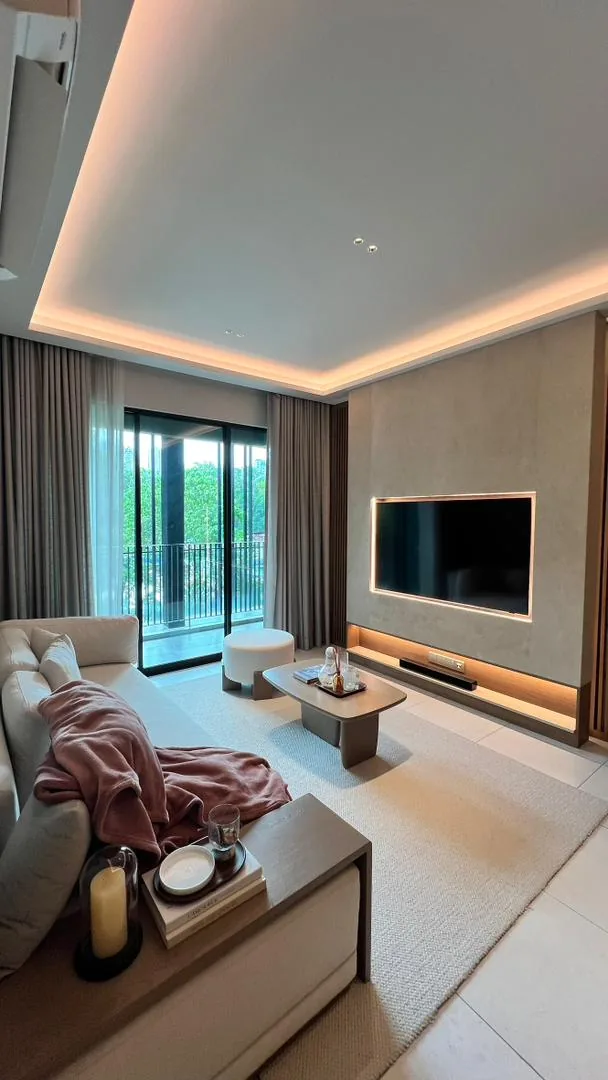 Amaya Residences show unit — living room with feature TV wall and balcony