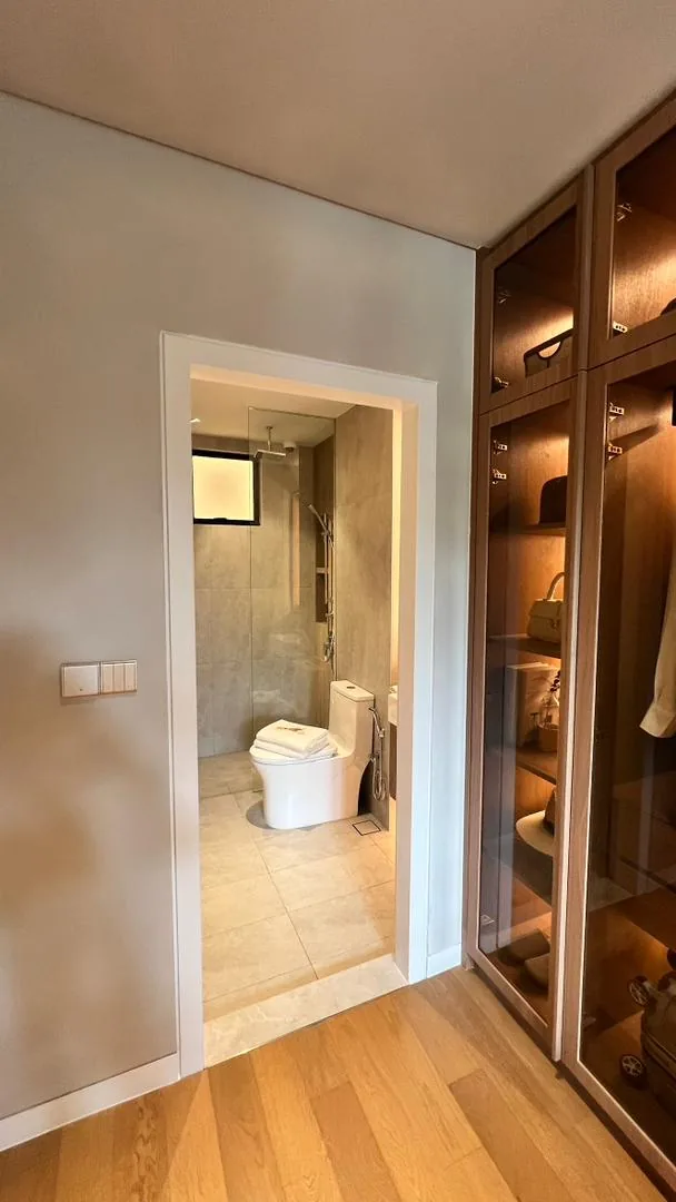 Amaya Residences show unit — walk-in wardrobe with glass cabinetry