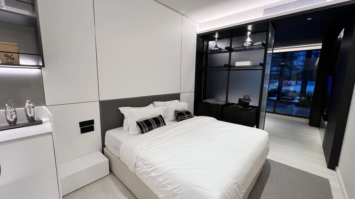 Armani Hallson show unit — bedroom with open wardrobe and city view