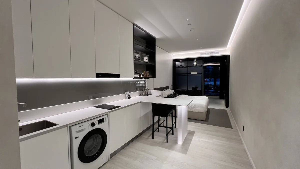 Armani Hallson show unit — kitchen with island and open living area