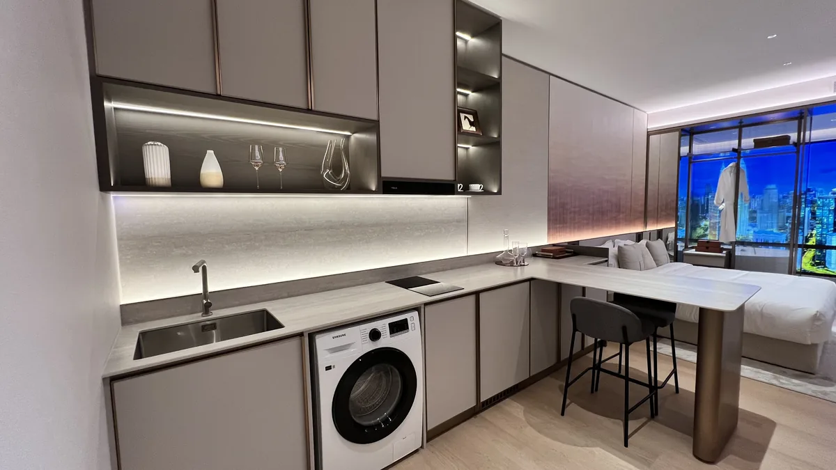 Armani Hallson show unit — studio kitchen with washer and dining nook