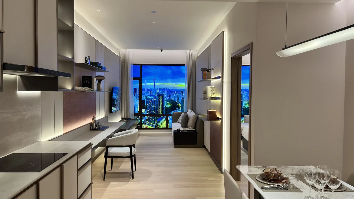 Armani Hallson show unit — living and dining area with the KLCC skyline at dusk