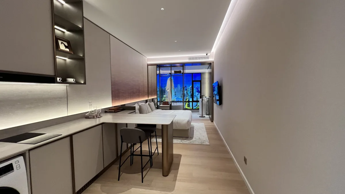 Armani Hallson show unit — open-plan studio with kitchen, dining and bed