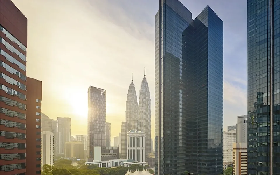 The Ritz-Carlton Residences, Kuala Lumpur — the tower above Berjaya Central Park with the Petronas Twin Towers beyond