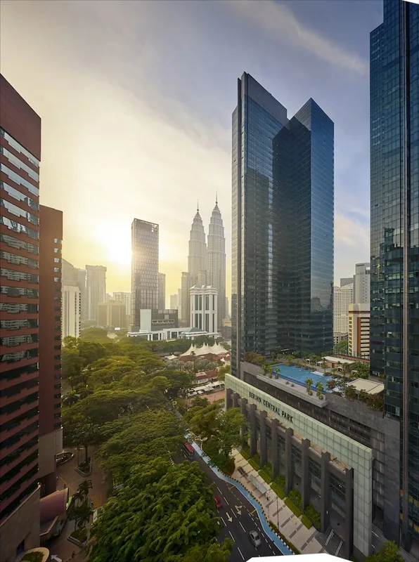 The Ritz-Carlton Residences, Kuala Lumpur — the tower above Berjaya Central Park with the Petronas Twin Towers beyond