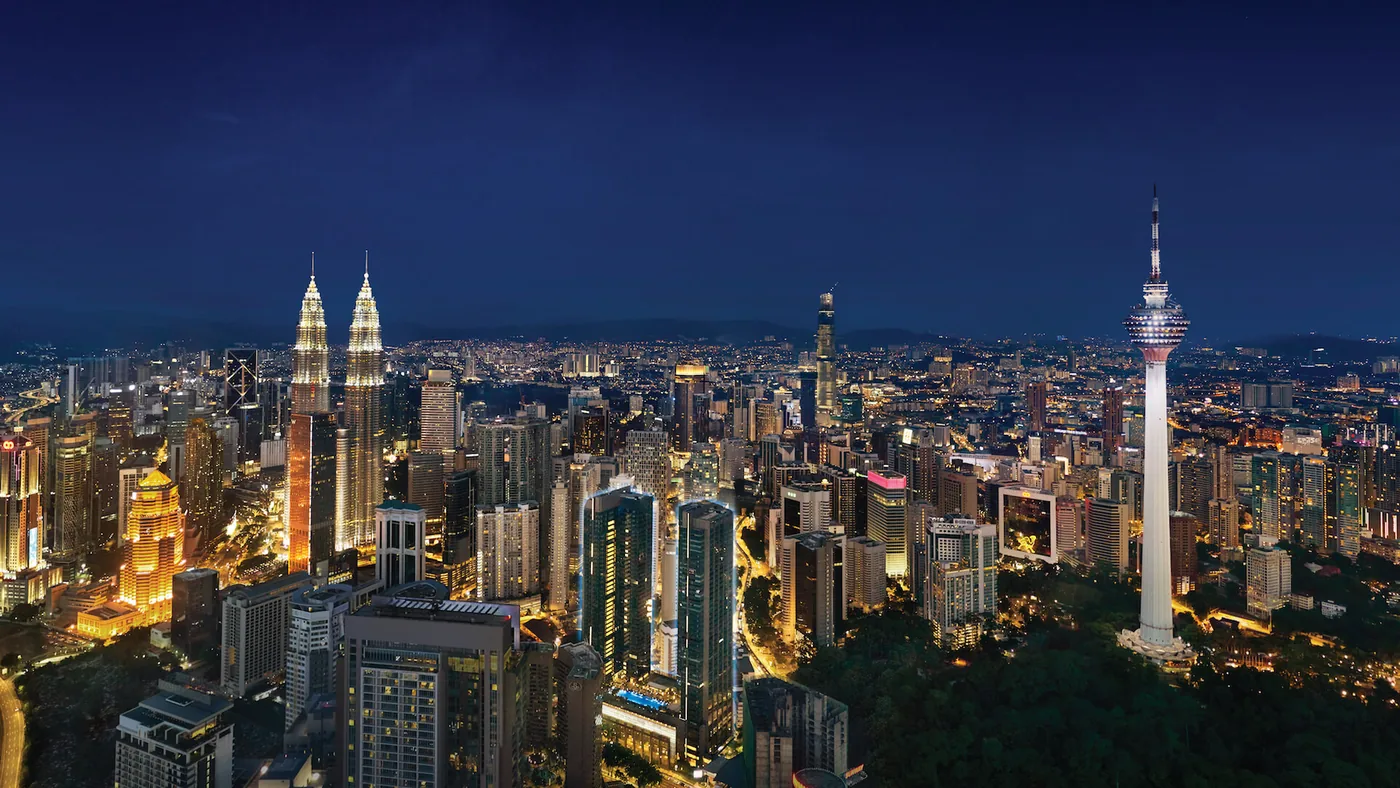 Kuala Lumpur city skyline at night — Petronas Twin Towers and KL Tower